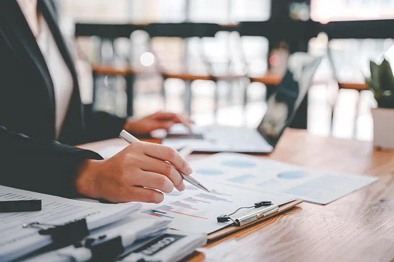 Woman sitting at desk going over financial documents